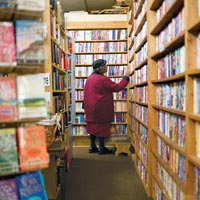 a woman browses the shelves at Bookie's Paperbacks and More in Chicago